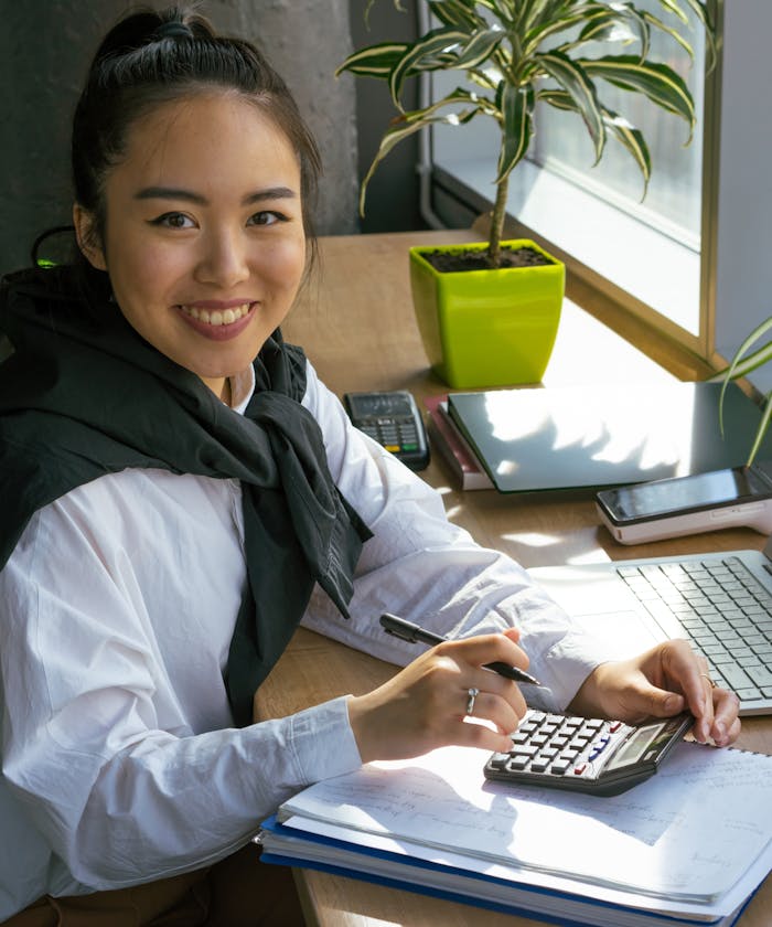 Accountant working at a bright desk by the window